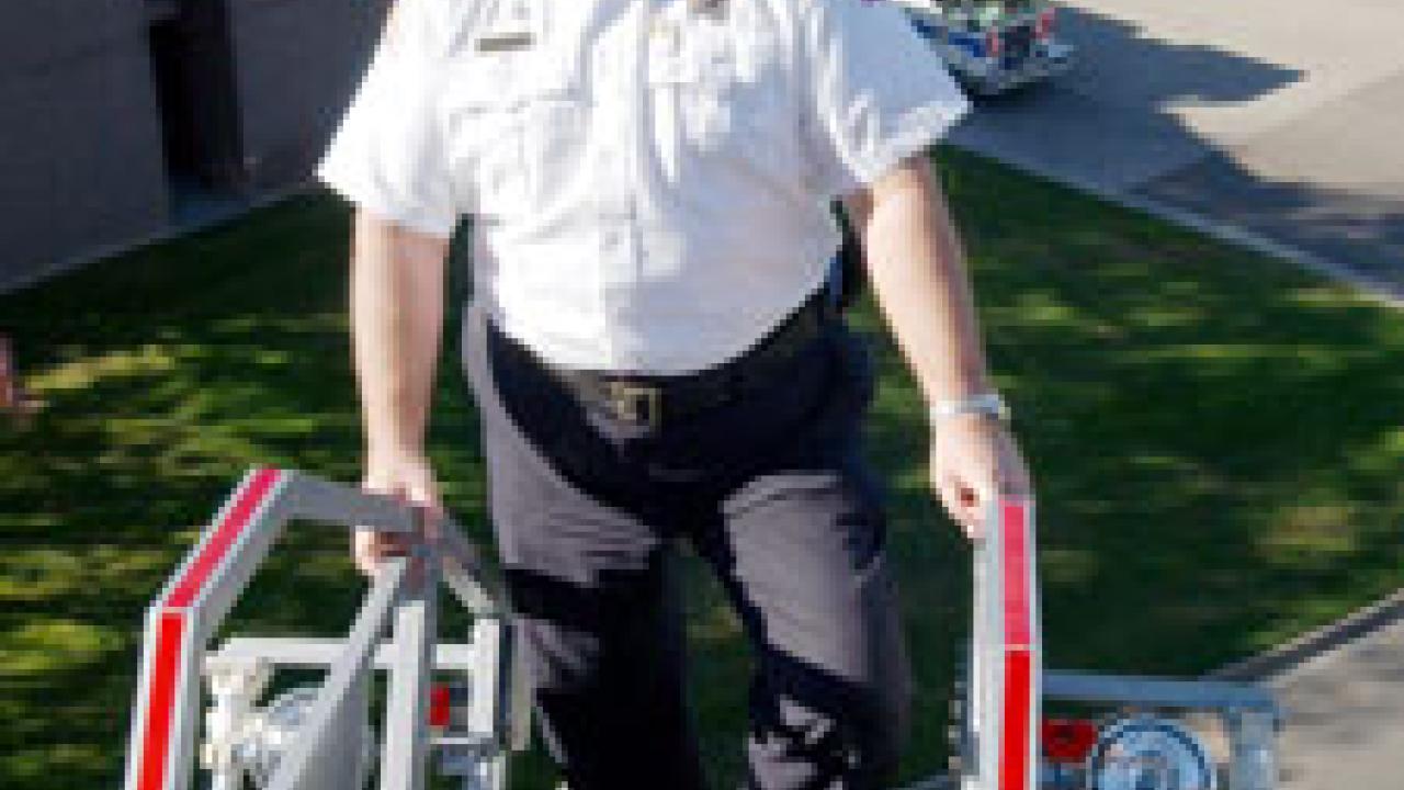 UC Davis Fire Chief Mike Chandler gets a bird&rsquo;s-eye view of the campus and fire station atop apparatus on the fire department&rsquo;s  105-foot ladder truck, which was put into service last year. A UC Davis alumnus &mdash; the chief is a former agricu