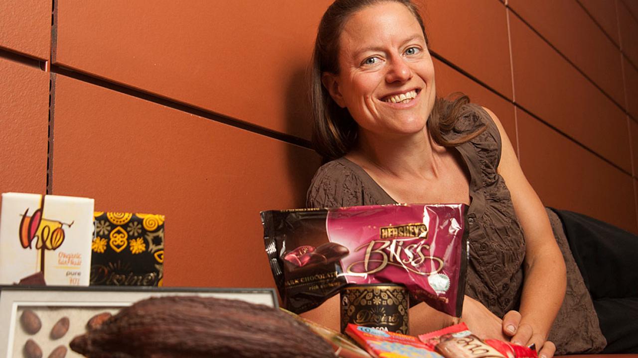 Woman lying on bench next to various chocolate foods