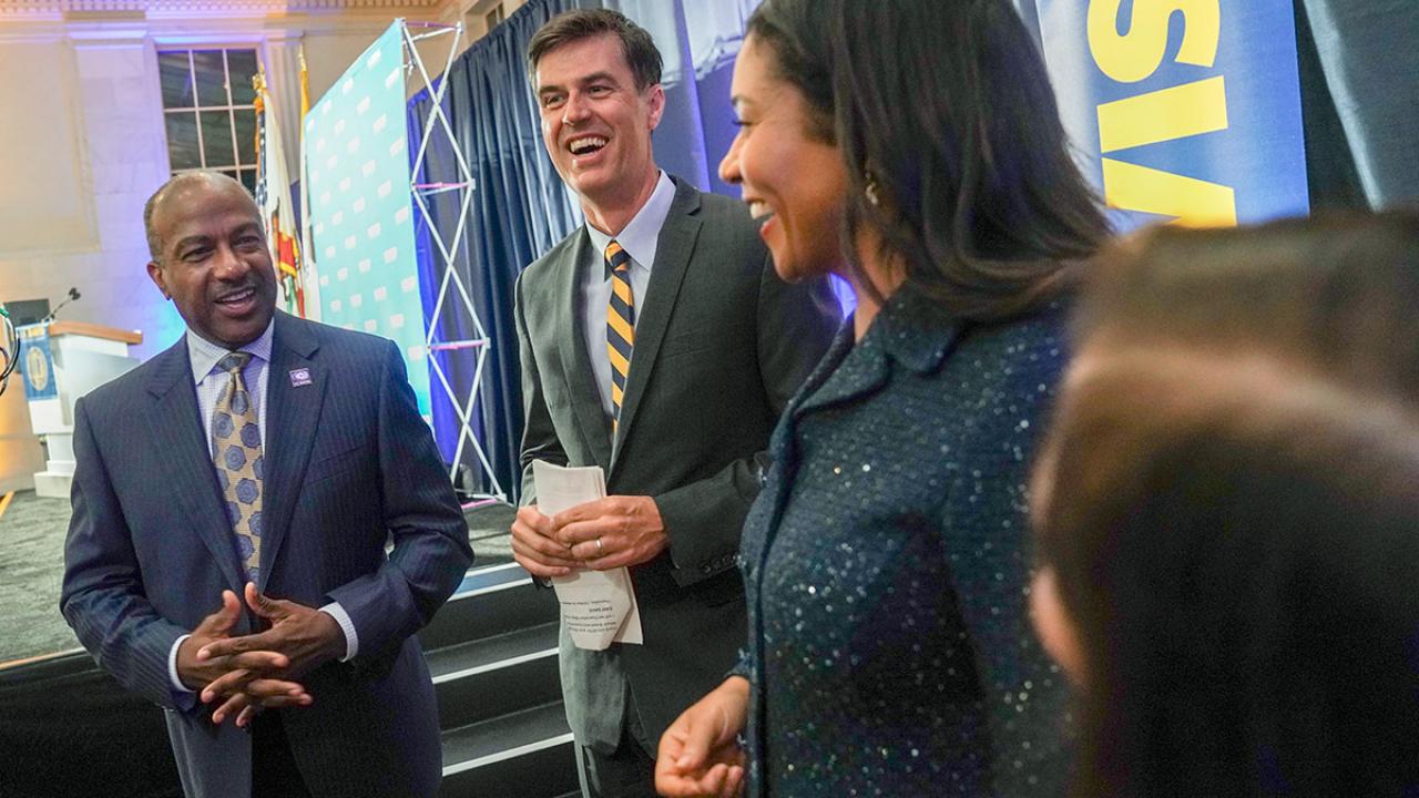 Chancellor Gary S. May with Dan Brown and London Breed.