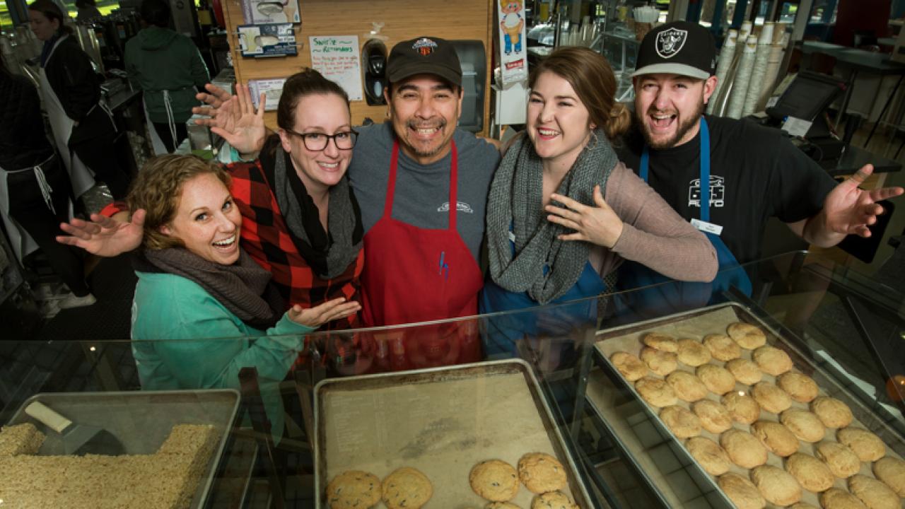 Photo: Coffee House managers all smiles beind the Swirlz bakery case.