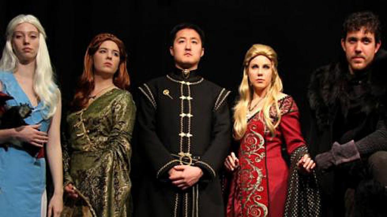 Five people in stage costumes
