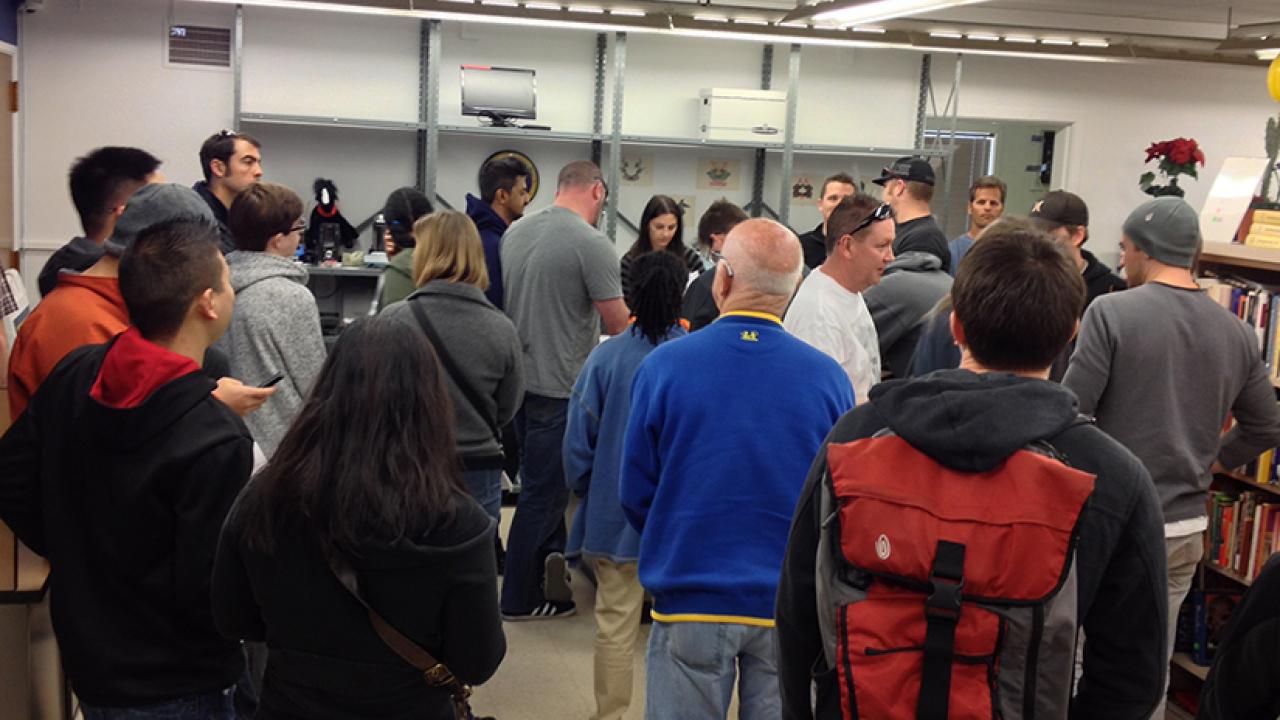 Photo: Crowd of potential bidders inside Aggie Surplus