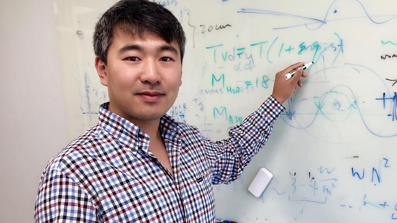 Scientist Da Yang at whiteboard 