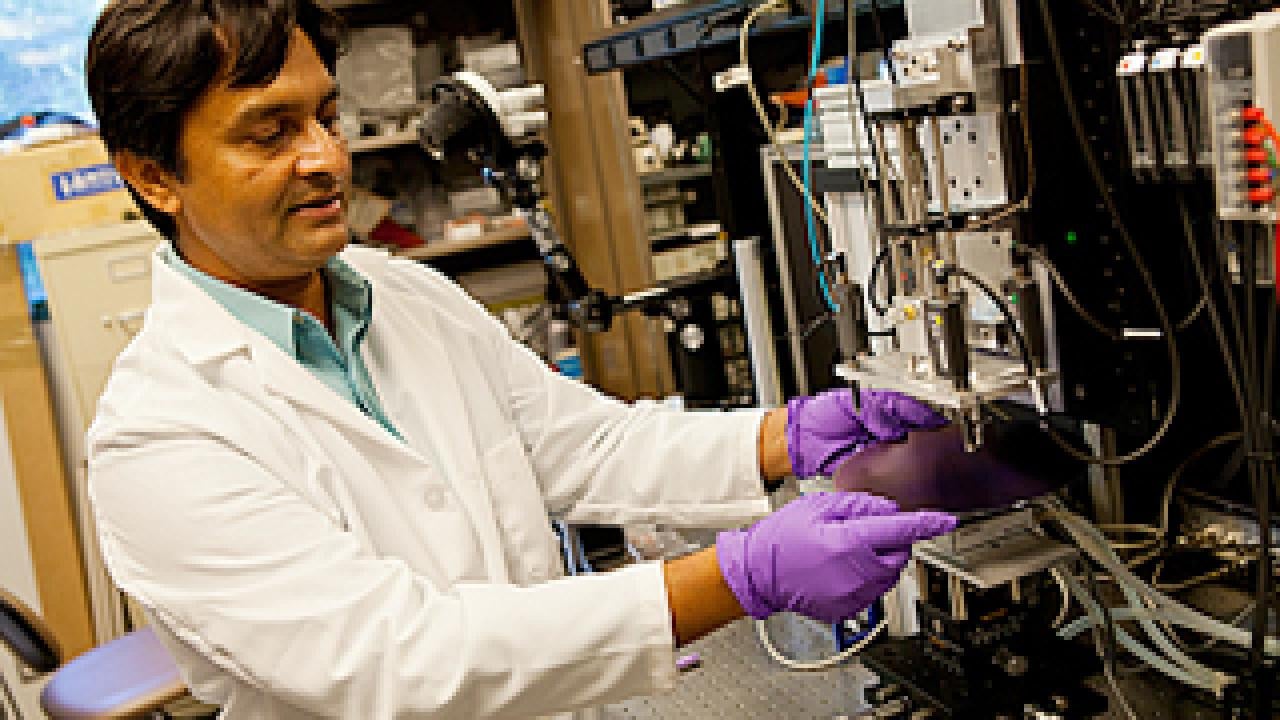 Researcher inserting disk into a machine
