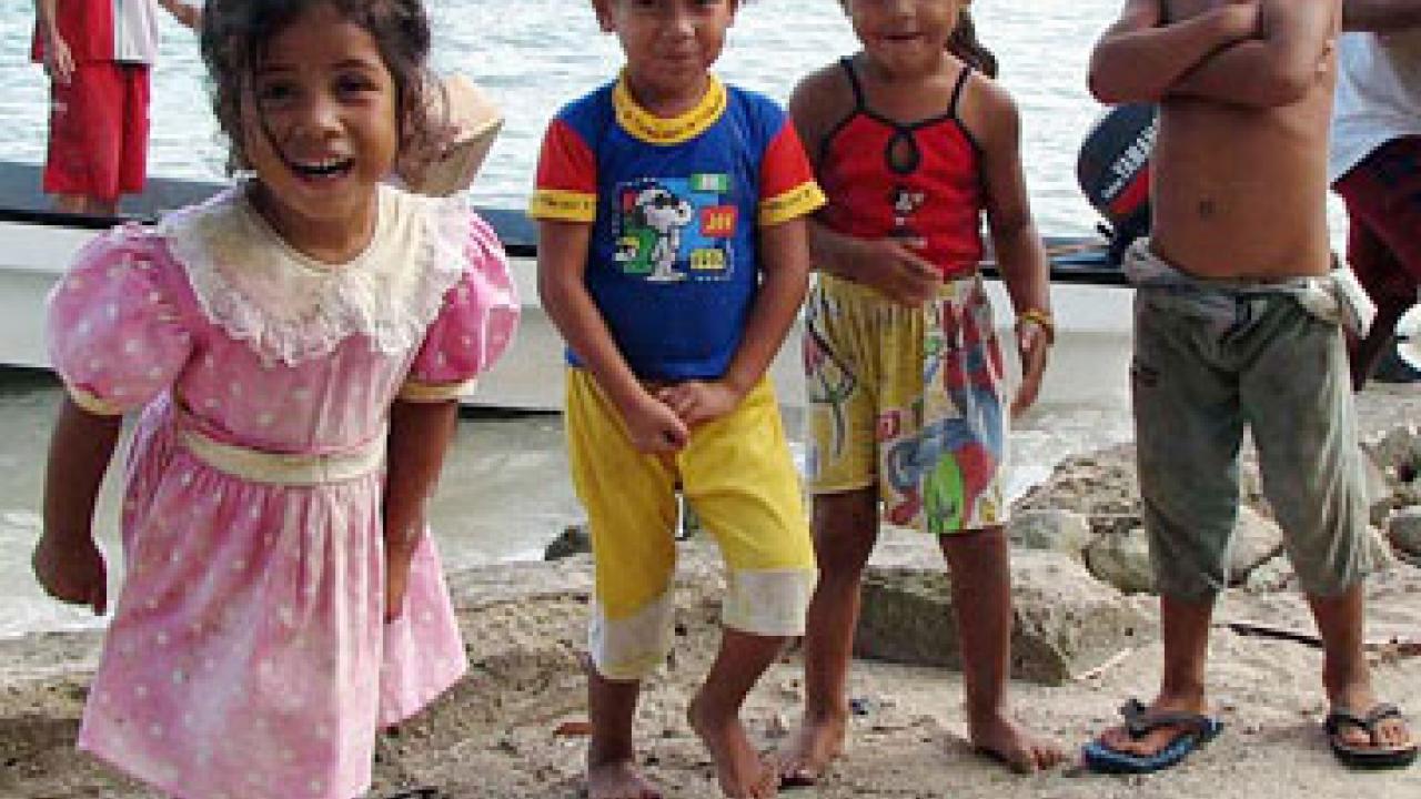 These children's parents left their island state of Tuvalu because of rising sea levels. Now they live on the Fijian island of Kioa, hundreds of miles away. They receive daily deliveries of food and household supplies by boat.