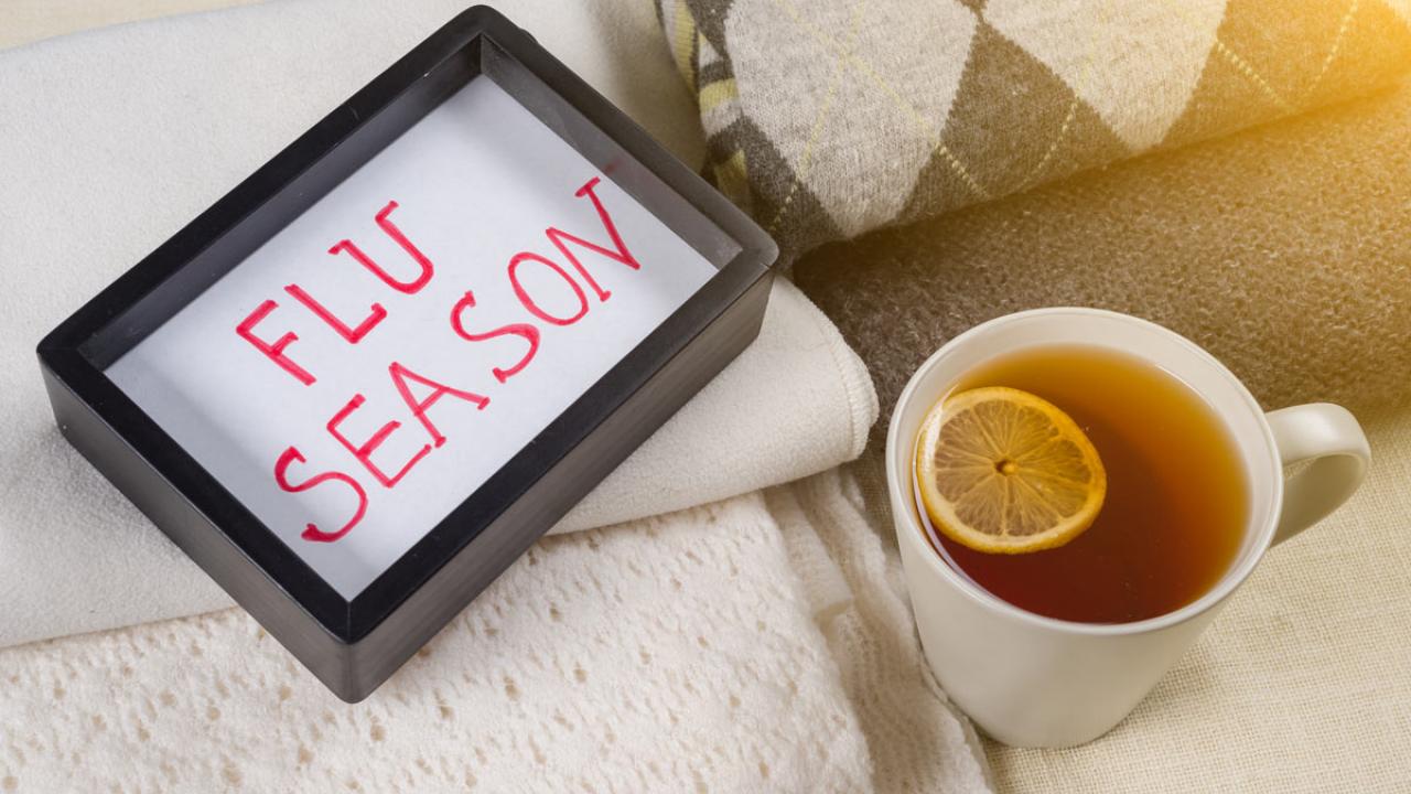 "Flu Season," written at bottom of serving tray, alongside a cup of tea.