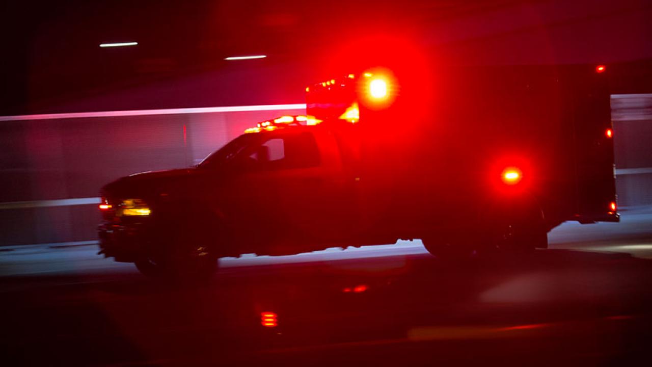 An ambulance with flashing lights at night