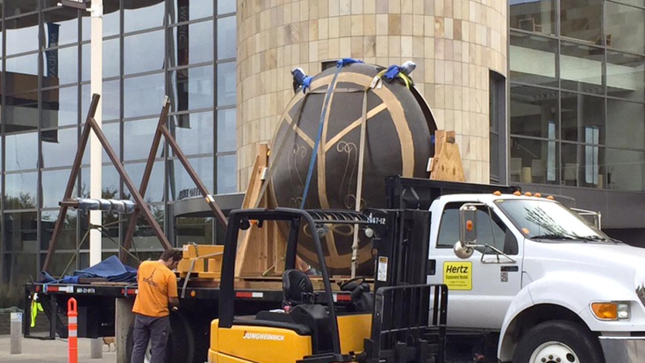 Photo: Forklift loads "Gong" onto a flatbed truck.