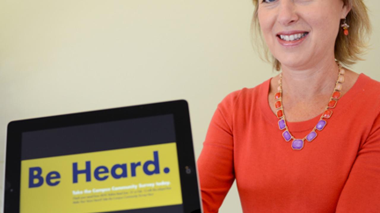 Photo: Kathy Henderson and her new iPad, open to the "Be Heard" slogan of the Campus Community Survey.