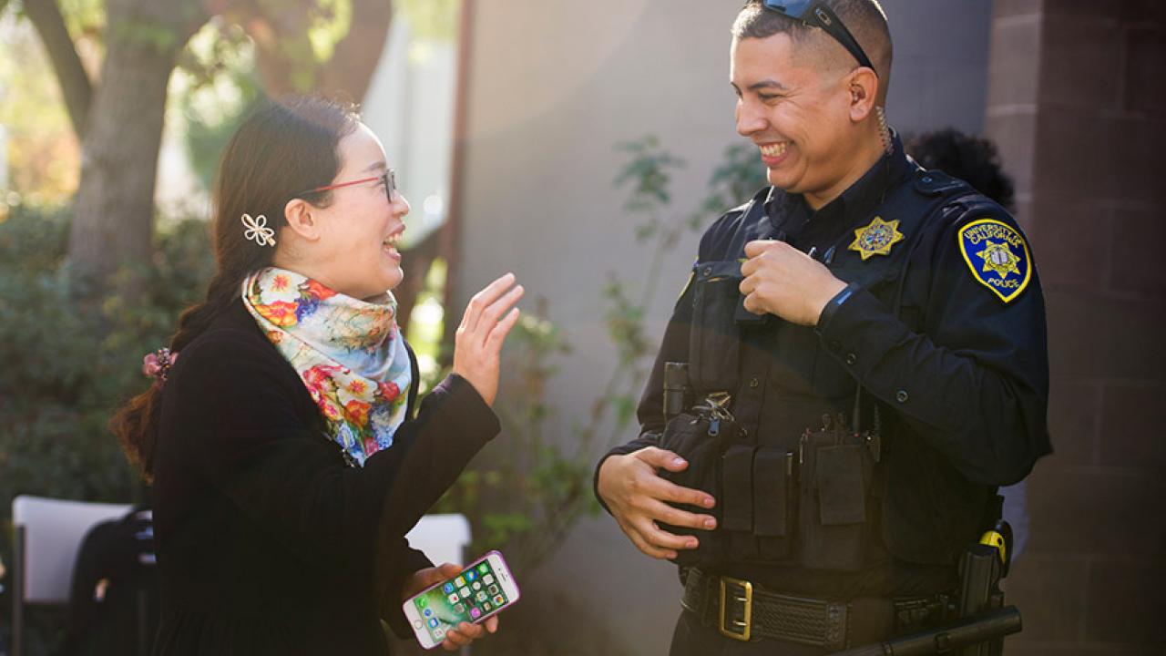 Songli Wang speaks with UC Davis police officer Jose Pinedo.