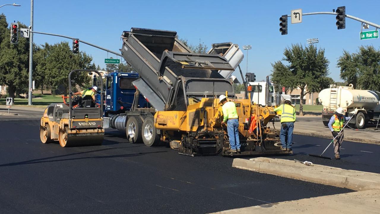 Workers repave intersection.