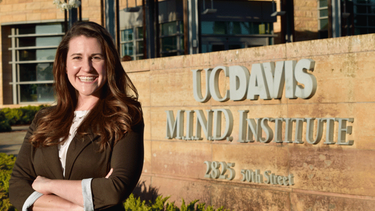 Photo: Jacqueline Barkoski poses at MIND Institute sign.