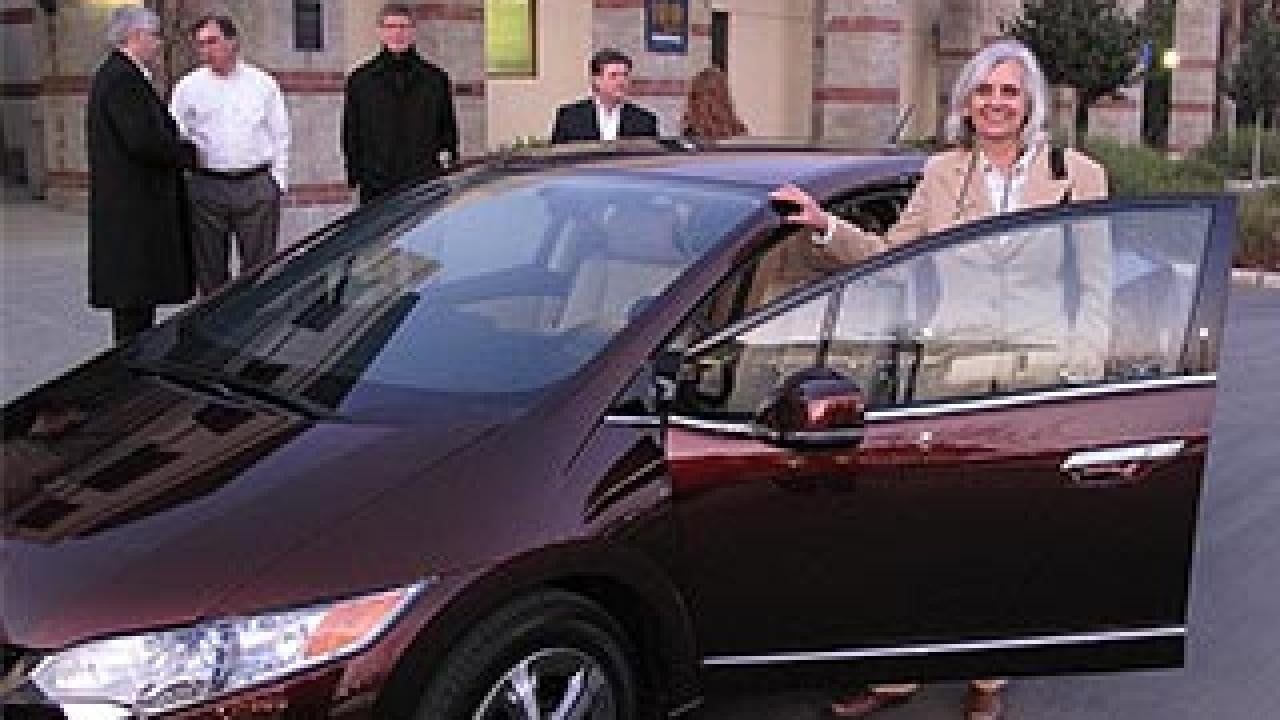 Woman about to get ready to get into a sleek purple car
