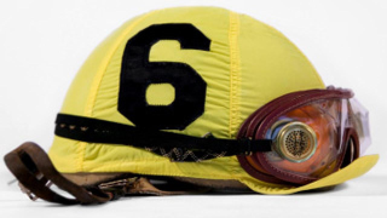 A numbered (6) jockey hat with goggles