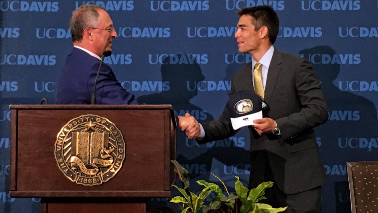 Acting Chancellor Ralph J. Hexter, left, welcomes Director of Athletics Kevin Blue at May 17 news conference.