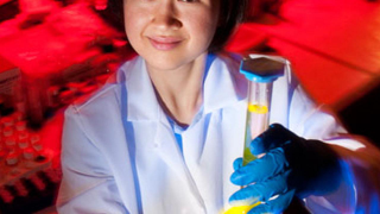 Larissa Miyachi holding a flask with yellow colored liquid
