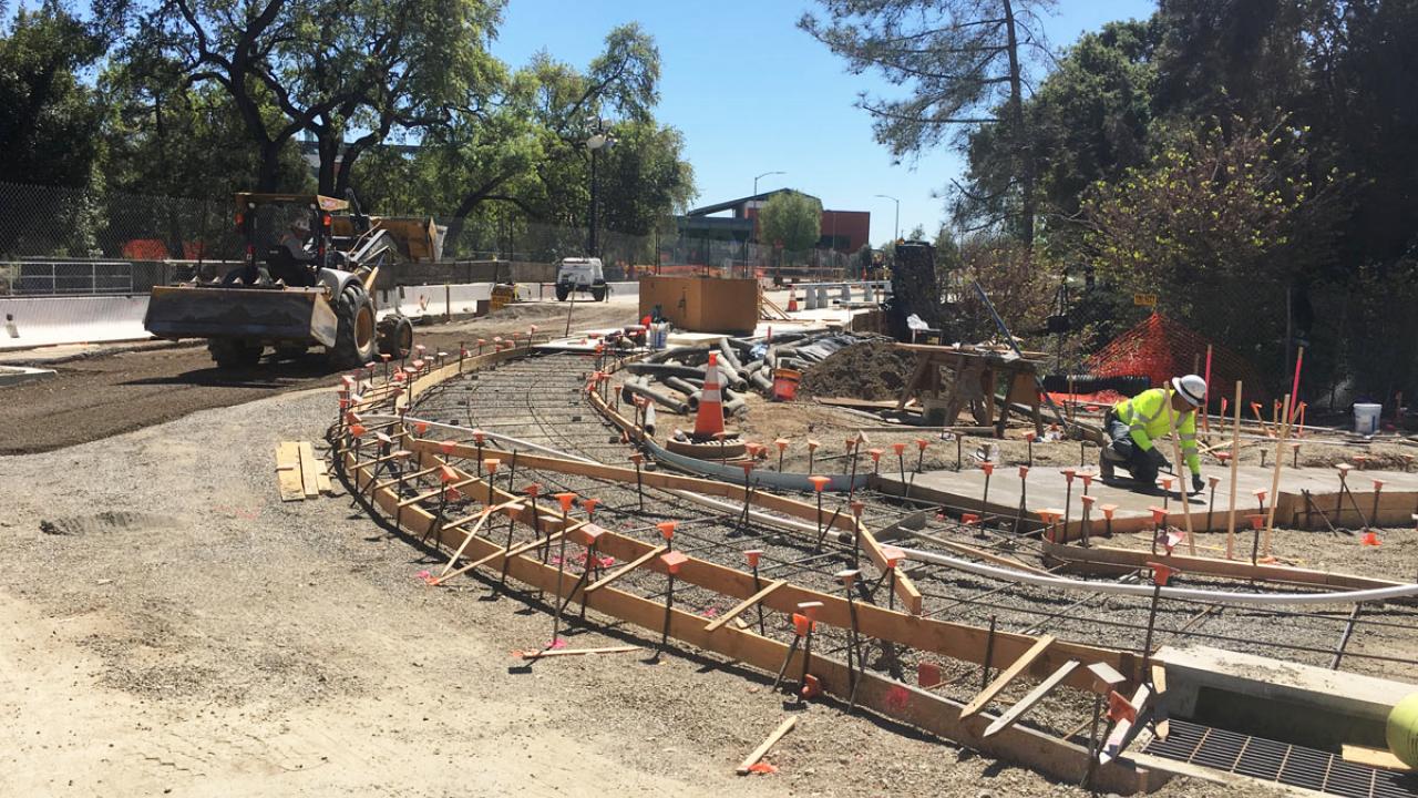 Road grading and sidewalk construction at bridge project