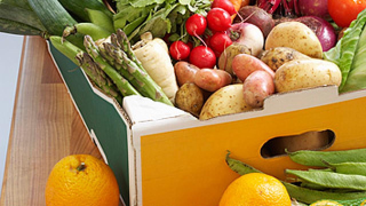 Photo: A box full of produce including leeks, basil, radishes, oranges, cauliflower