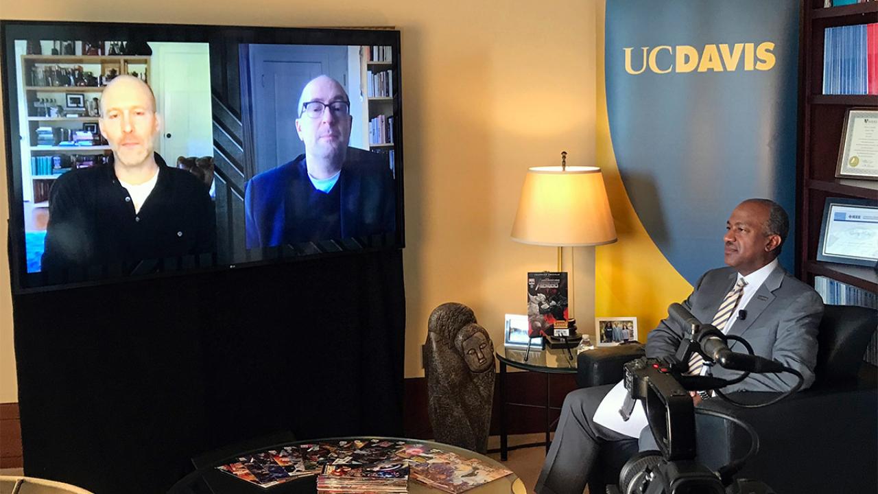 Chancellor Gary S. May filming a video chat with two other men.