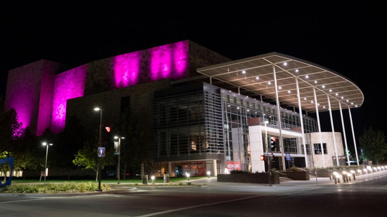 Purple lights at night on Mondavi Center's south wall