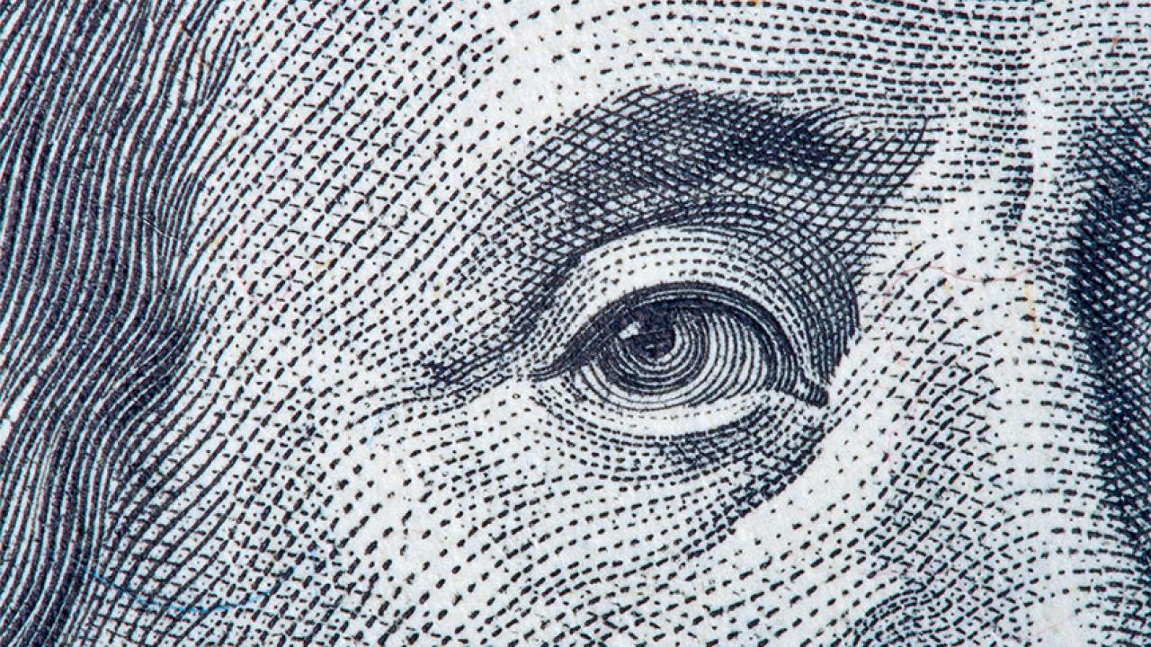 A closeup of a face on money