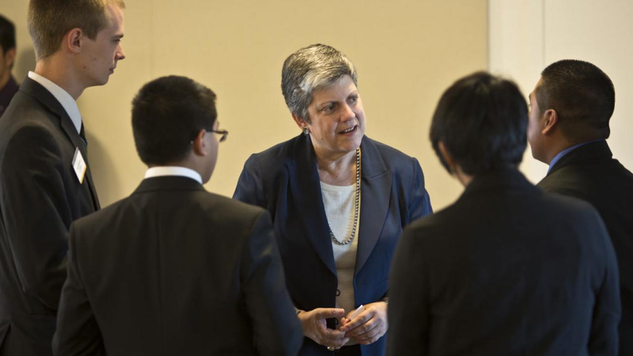 Janet Napolitano interacts with UC Merced students who are gathered in a half circle around her.