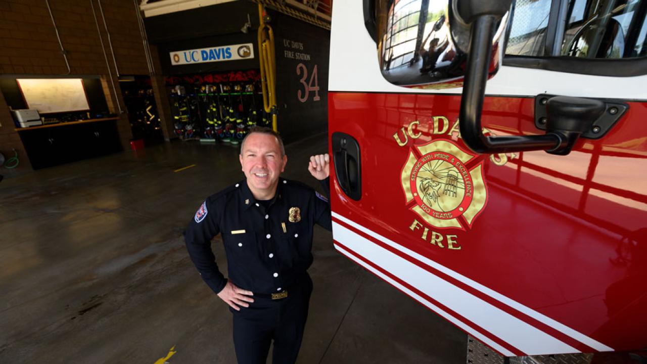 Fire Chief Nate Trauernicht poses next to firetruck.