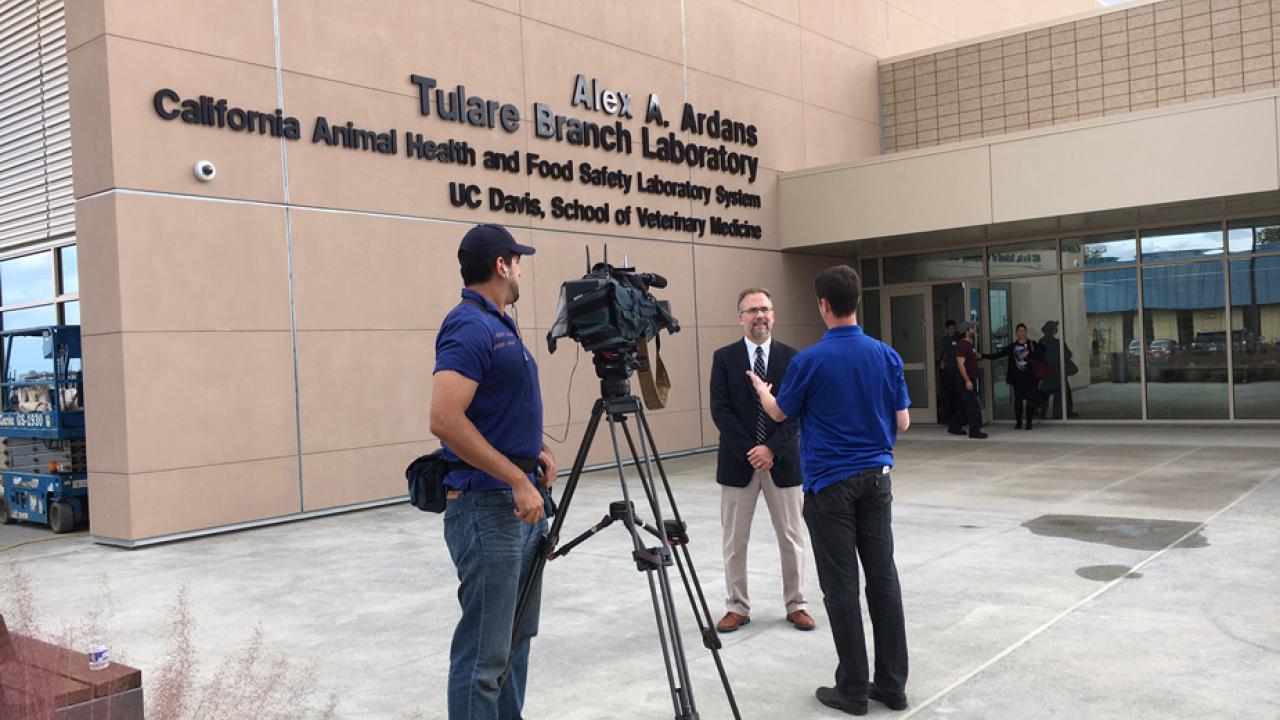 Photo: TV crew interviews a man in front of the new lab.