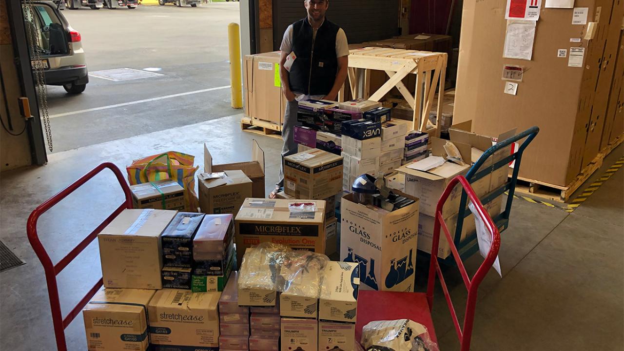 Man standing with donated supplies.