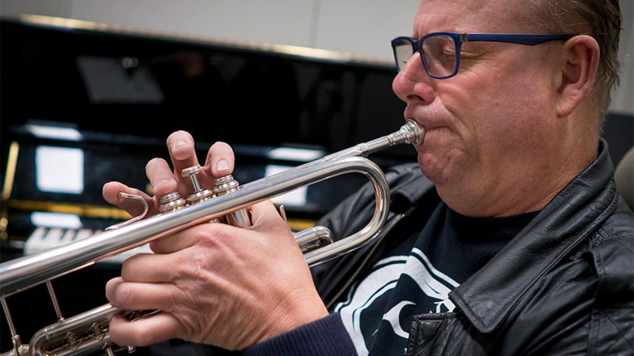 A man plays the trumpet.