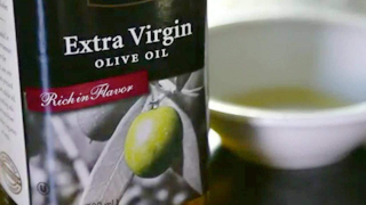 Olive oil can with bowl of olive oil