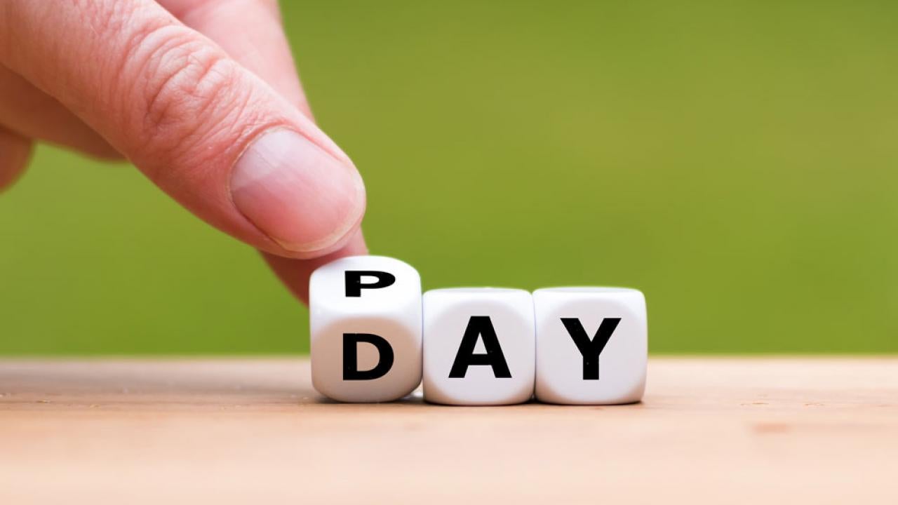 "Pay Day" spelled out on dice.