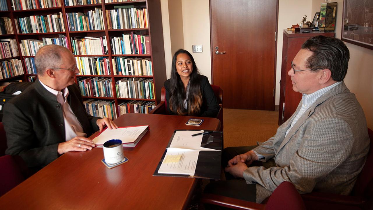 Ralph J. Hexter sits at a table with Namrata Kumar and Kevin Johnson.