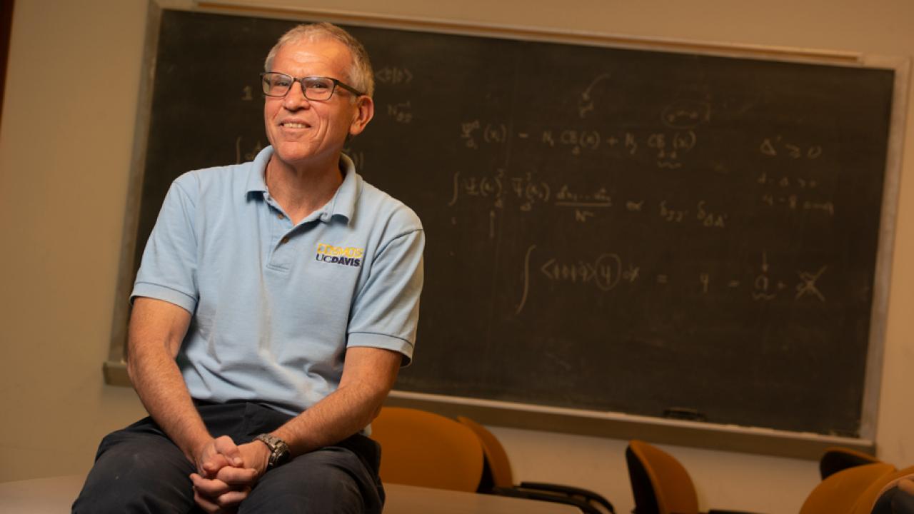 Professor Richard Scalettar, seated in front of blackboard