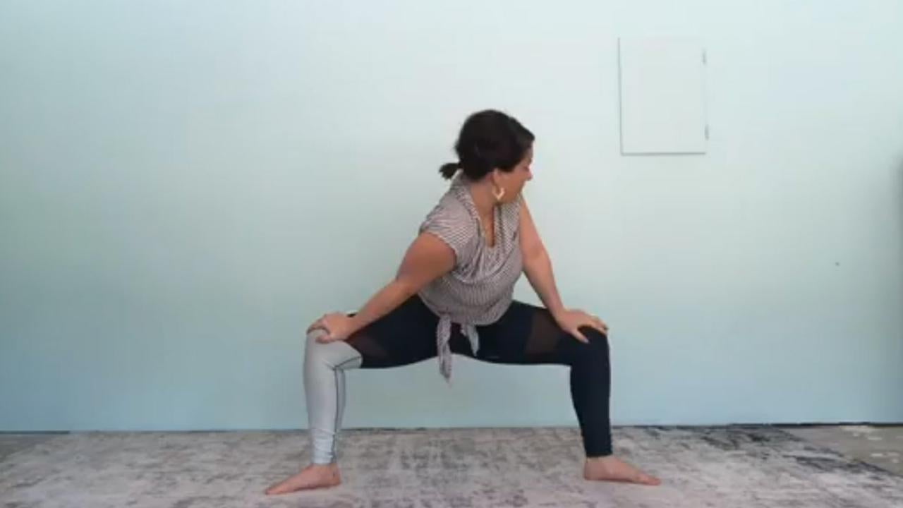 Woman stands in yoga pose