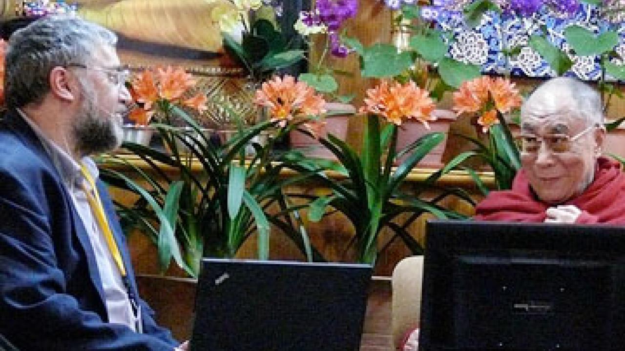 Photo: Cliff Saron, left, gazes at Dalai Lama, with computer screens and flowers