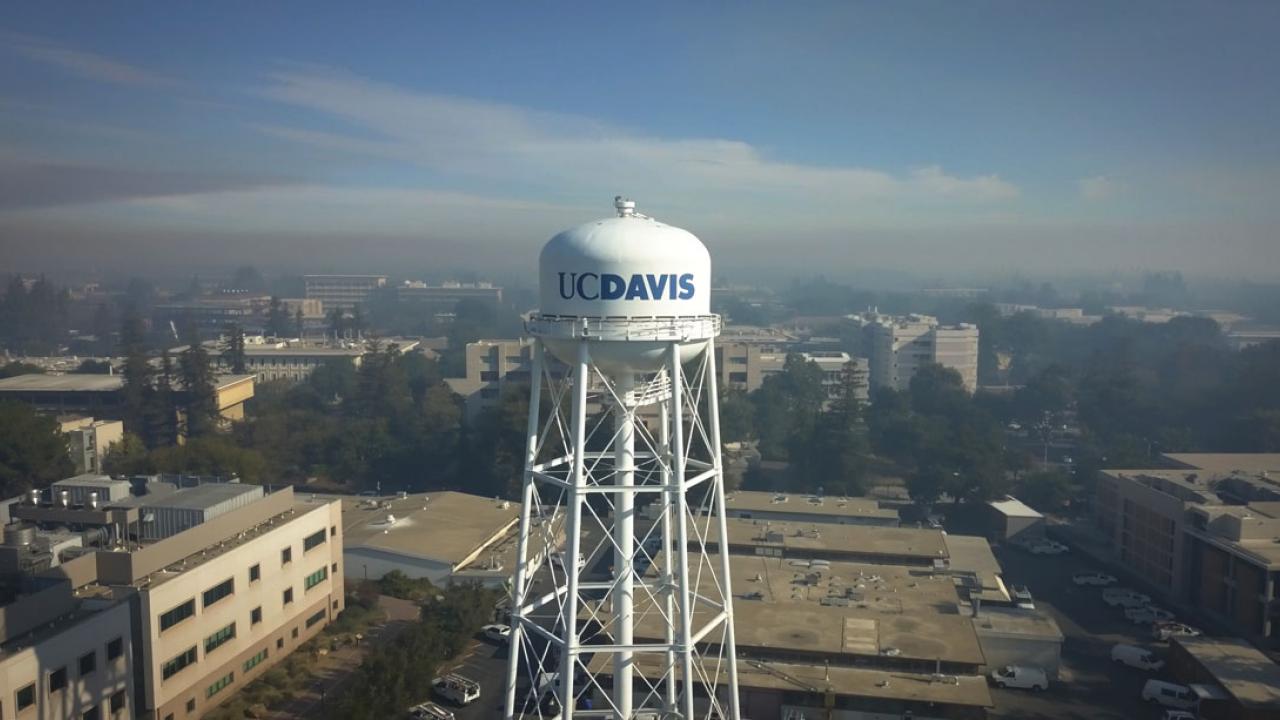 Smoke over the campus, main "UC Davis" water tower in foreground.