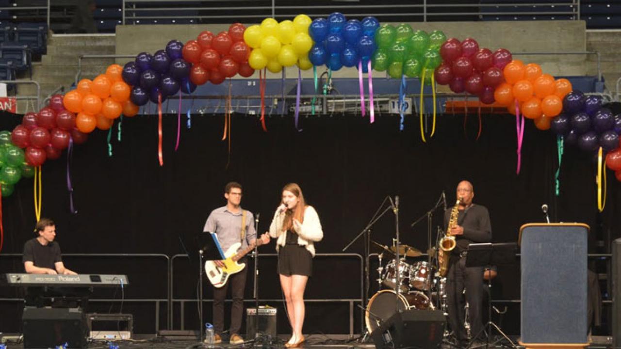 Band performs under rainbow-colored balloon arch at Soaring to New Heights, 2016.h 