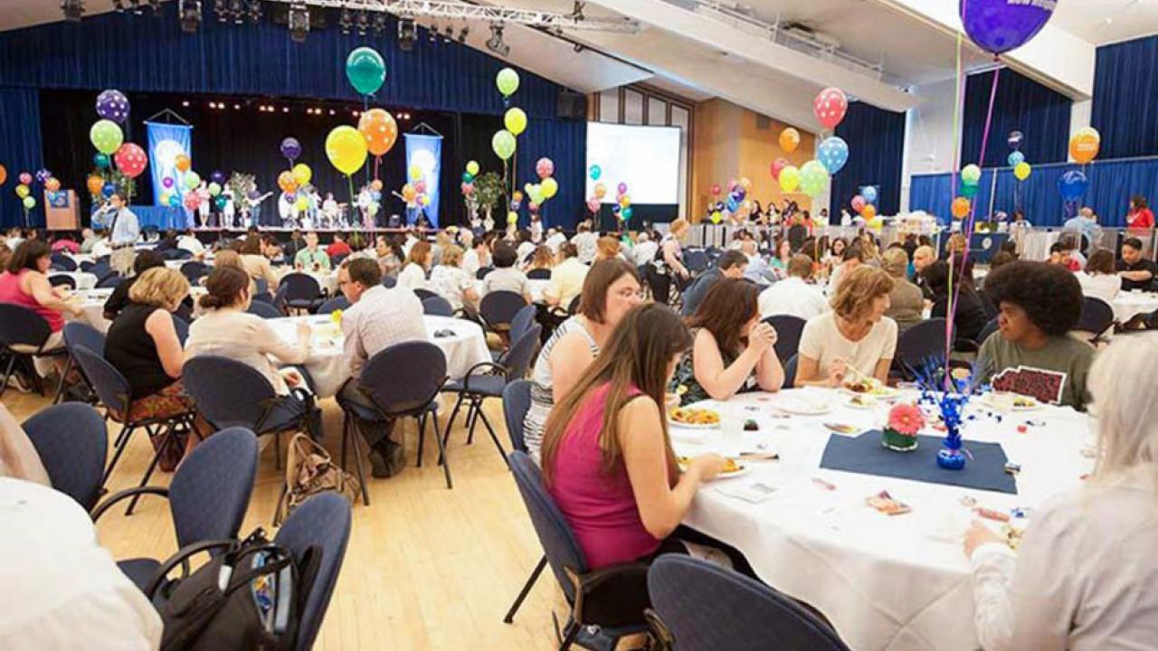 Luncheon event, circular tables with balloons, in Freeborn Hall