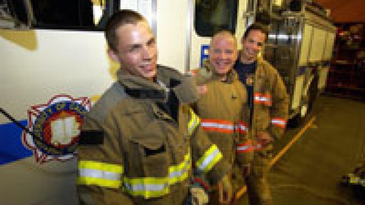 photo of campus student resident firefighter Kevin Taylor and two career firefighters