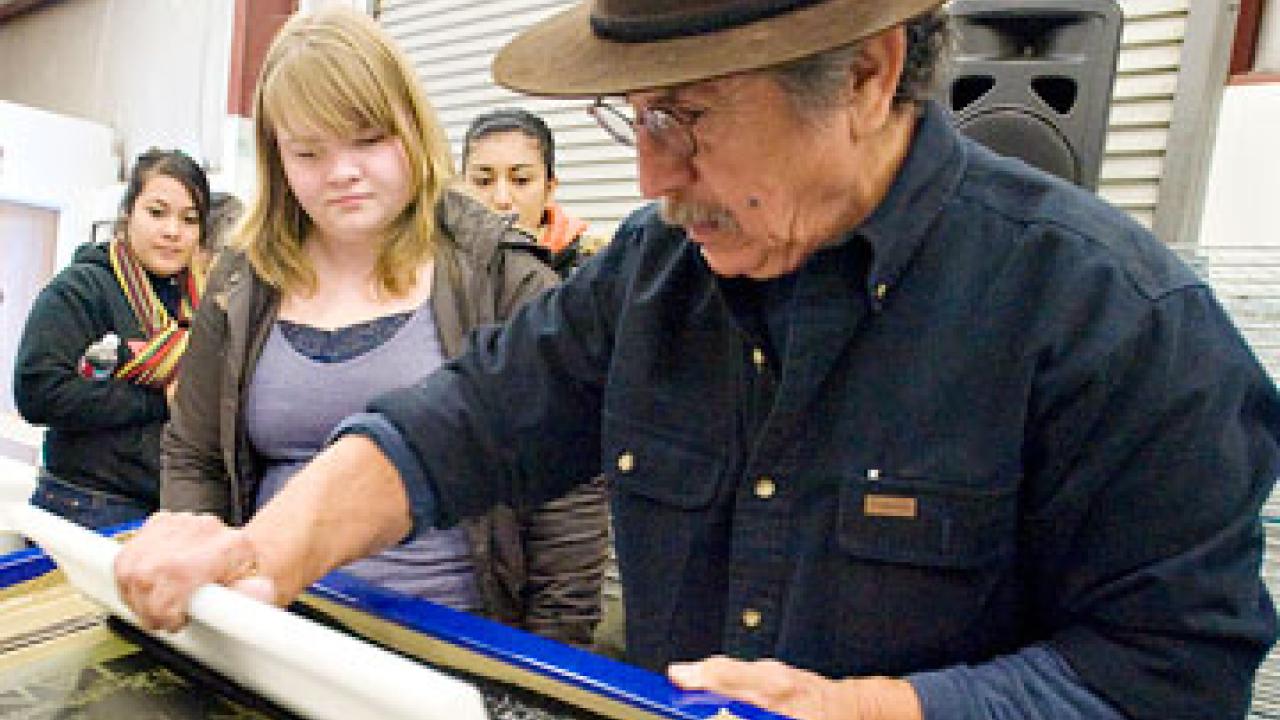 Photo: Malaquias Montoya demonstrating silk screening
