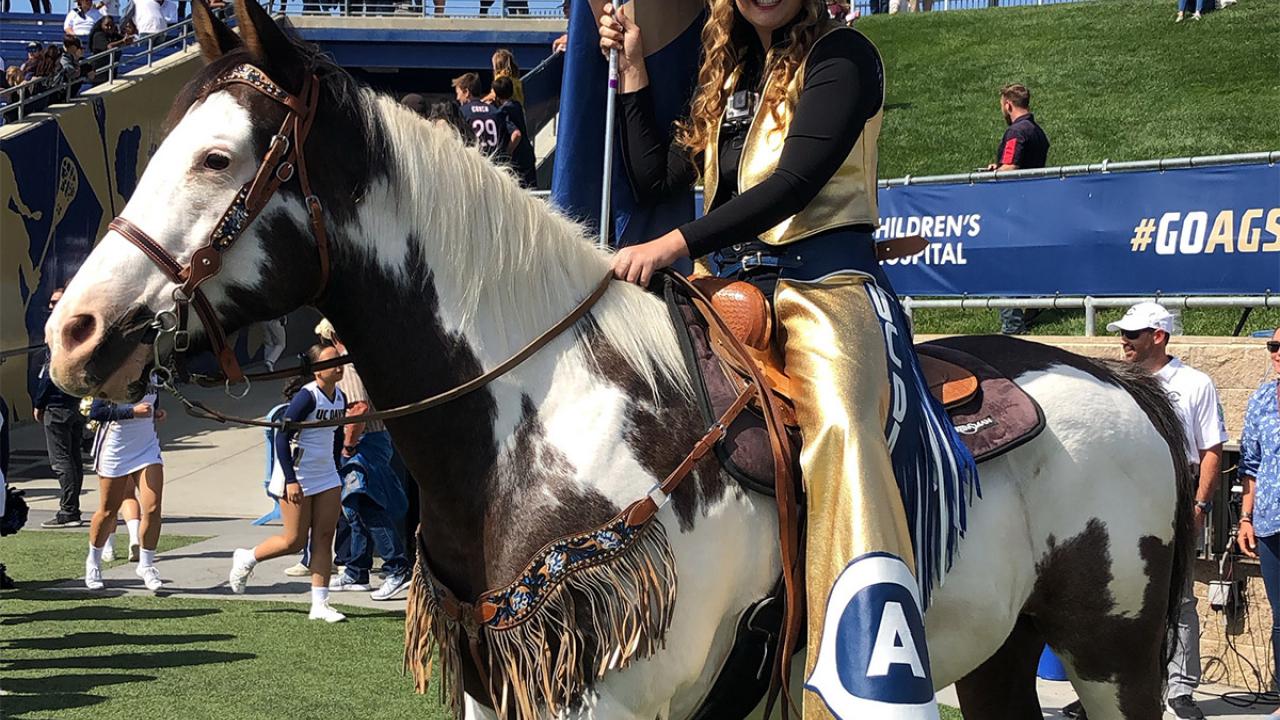Tatum Burris on a horse at the football game.