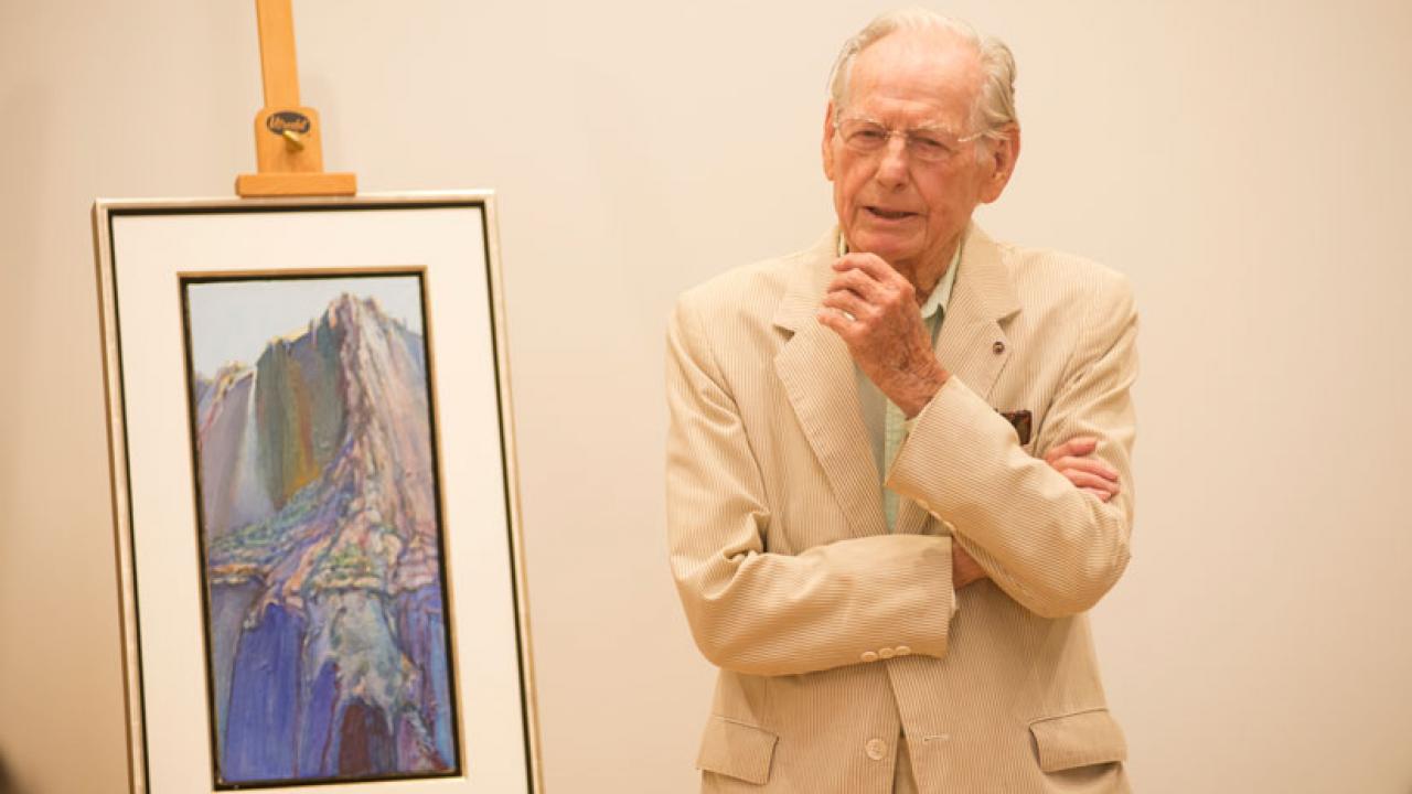 Photo: Wayne Thiebaud addresses gathering, while standing in front of his painting "Yosemite."