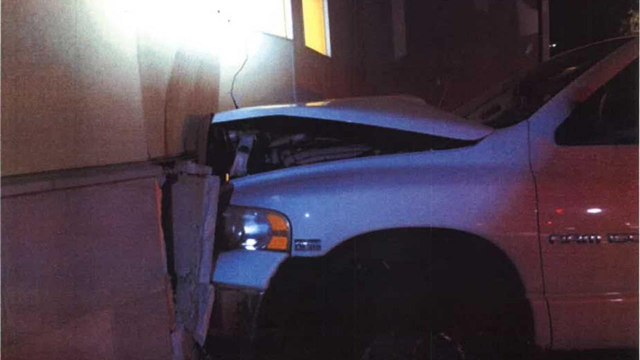 Pickup with front end partially inside residence hall.