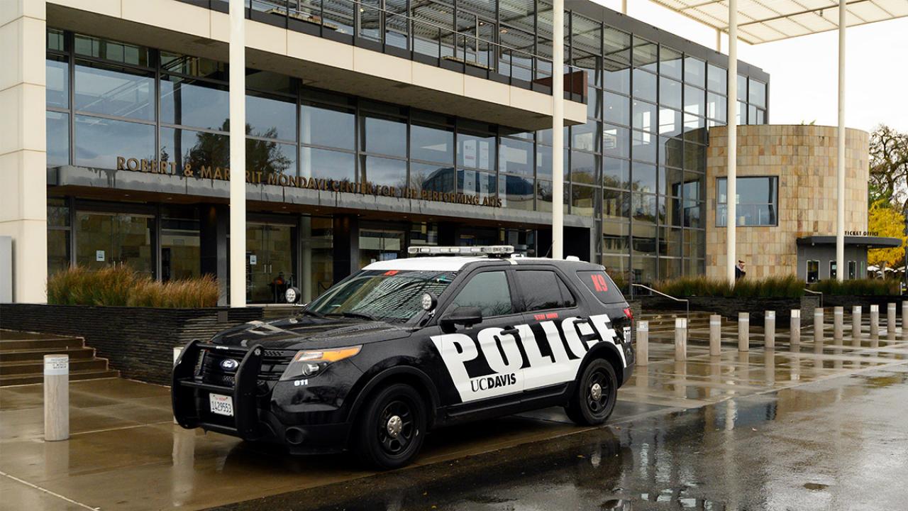 A UC Davis police car in front of the Mondavi Center.