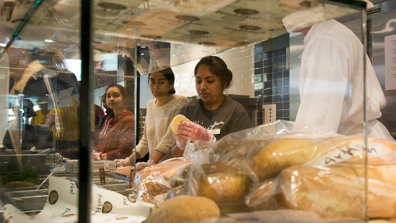 Students practice making sandwiches.