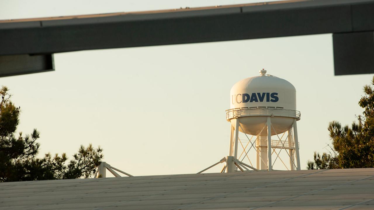 UC Davis water tower in background, with solar panels in foreground.