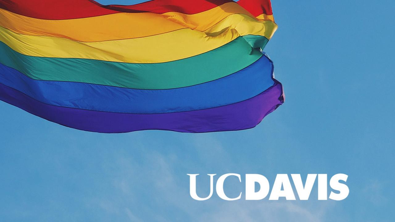 A photo of the rainbow pride flag with UC Davis superimposed over the top.