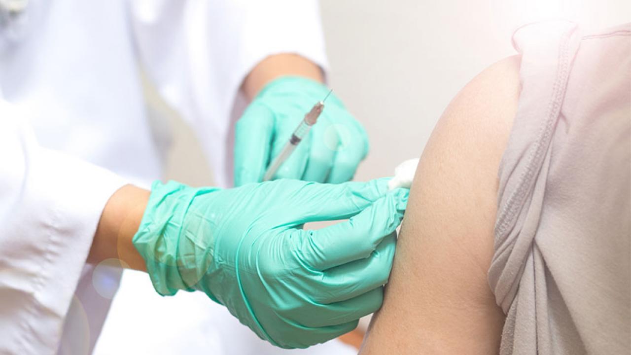 A closeup of a nurse vaccinating a patient