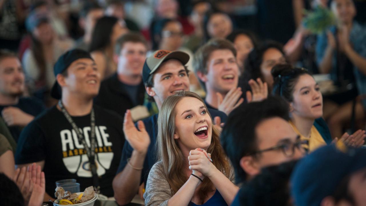 Students watch UC Davis-Kansas basketball game, at watch party in Segundo Dining Commons.